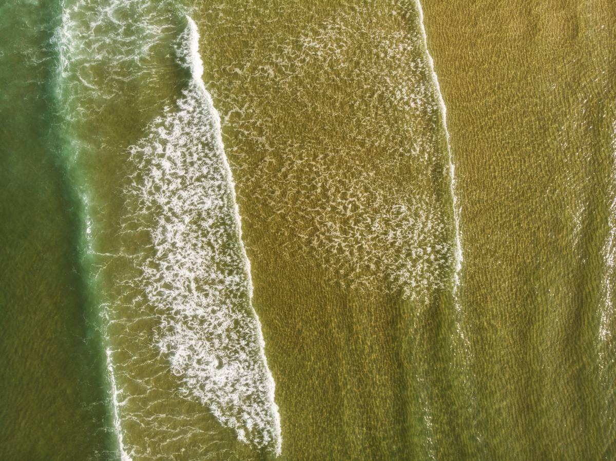 A set of velvet hair rollers neatly arranged on a white table.