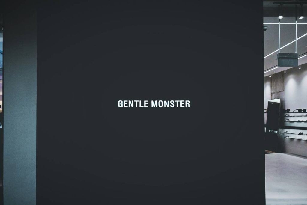 a black wall with the words gentle monster written on it