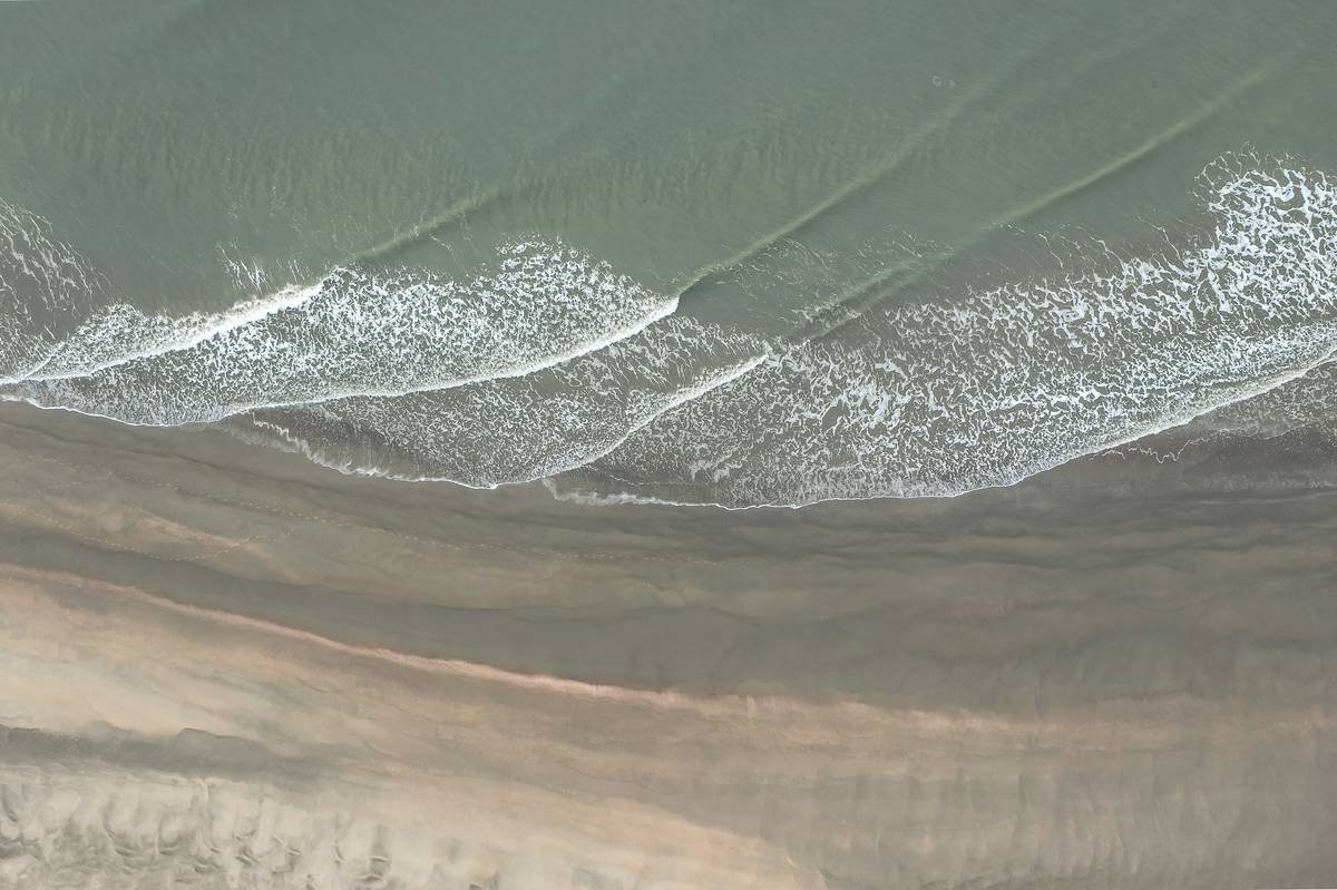 Drone with of north sea beach with calm waves.