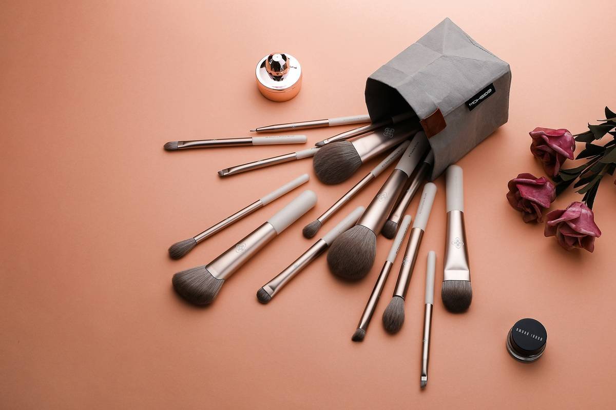 woman using soft curlers on damp hair for heatless waves