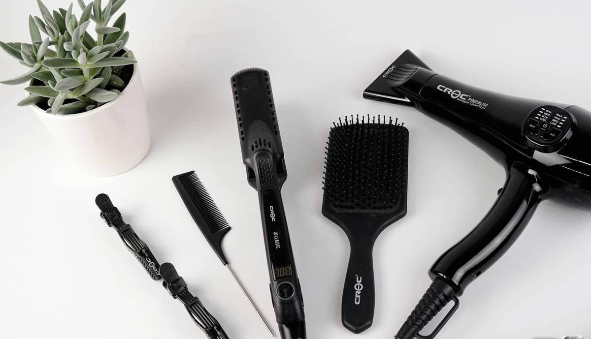 Woman using no-heat styler with silk hair rollers on damp hair overnight for natural waves